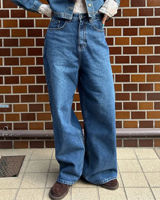 Wide-leg jeans with faded whisker wash.