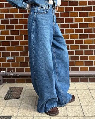 Wide-leg jeans with faded whisker wash.