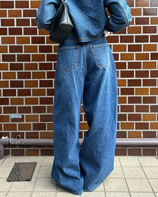 Wide-leg jeans with faded whisker wash.