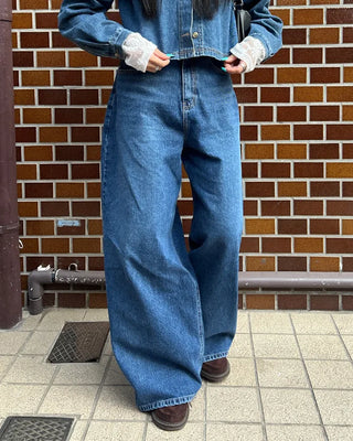 Wide-leg jeans with faded whisker wash.