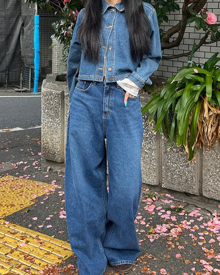 Wide-leg jeans with faded whisker wash.