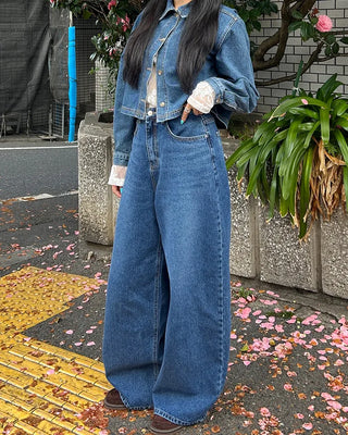Wide-leg jeans with faded whisker wash.