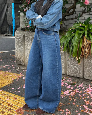 Wide-leg jeans with faded whisker wash.