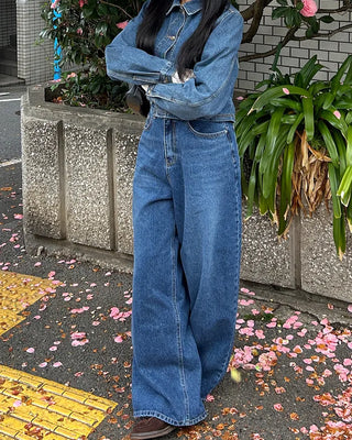 Wide-leg jeans with faded whisker wash.