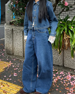 Wide-leg jeans with faded whisker wash.