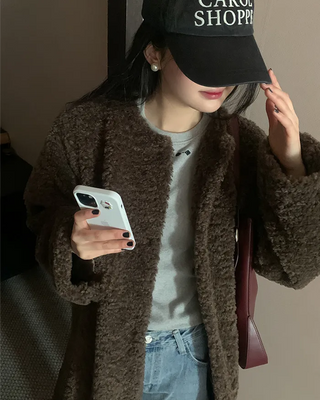 Collarless boucle fur coat