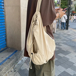 Drawstring pocket shoulder bag