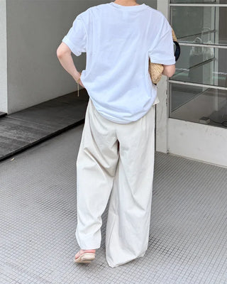 Wide-leg pants with pleats and peplum belt