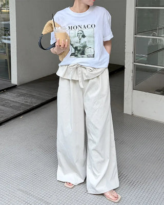 Wide-leg pants with pleats and peplum belt