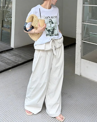 Wide-leg pants with pleats and peplum belt