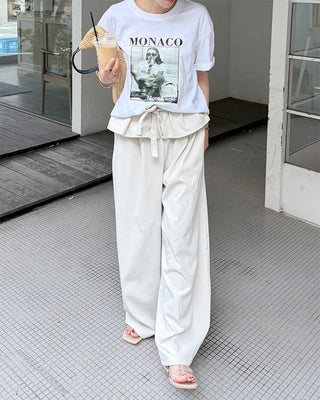 Wide-leg pants with pleats and peplum belt