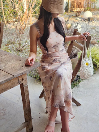 Beige long one-piece dress with a sleeveless shirring slim square neck and straps for a resort vacation look.