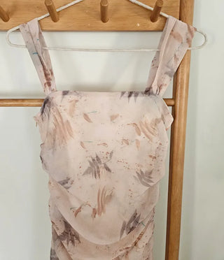Beige long one-piece dress with a sleeveless shirring slim square neck and straps for a resort vacation look.