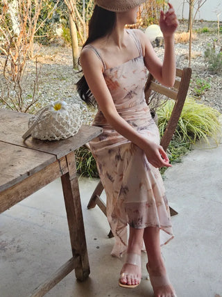 Beige long one-piece dress with a sleeveless shirring slim square neck and straps for a resort vacation look.