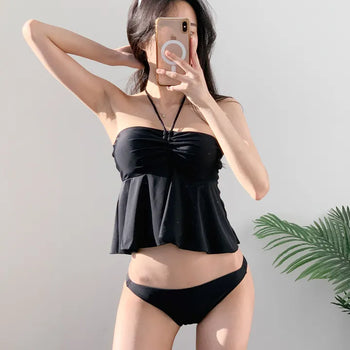 Low-rise halterneck black swimsuit bikini swimwear holiday look shirring and resort look