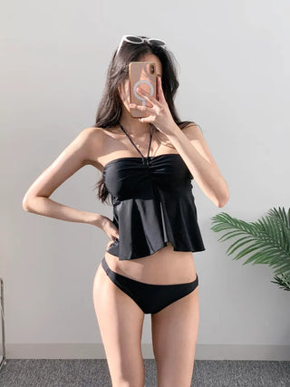 Low-rise halterneck black swimsuit bikini swimwear holiday look shirring and resort look