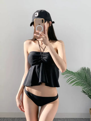 Low-rise halterneck black swimsuit bikini swimwear holiday look shirring and resort look