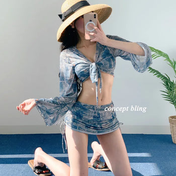Vintage denim piece bikini with cardigan cover-up skirt and string body-covering tummy-covering swimsuit