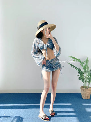 Vintage denim piece bikini with cardigan cover-up skirt and string body-covering tummy-covering swimsuit
