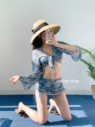 Vintage denim piece bikini with cardigan cover-up skirt and string body-covering tummy-covering swimsuit