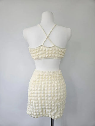Embossed piece bikini with a vacation check ivory strap and a unique piece skirt.