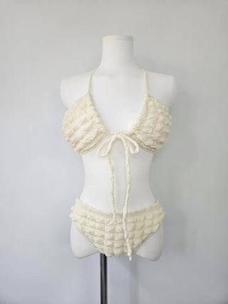 Embossed piece bikini with a vacation check ivory strap and a unique piece skirt.