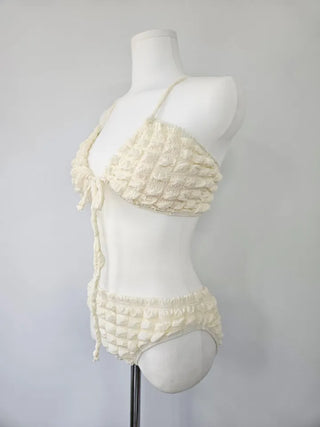 Embossed piece bikini with a vacation check ivory strap and a unique piece skirt.