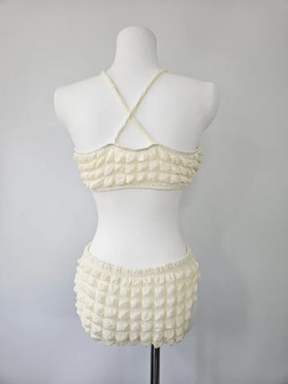 Embossed piece bikini with a vacation check ivory strap and a unique piece skirt.