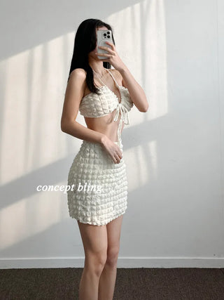 Embossed piece bikini with a vacation check ivory strap and a unique piece skirt.
