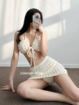 Embossed piece bikini with a vacation check ivory strap and a unique piece skirt.