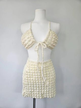Embossed piece bikini with a vacation check ivory strap and a unique piece skirt.