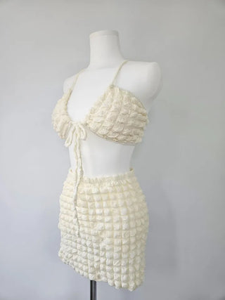 Embossed piece bikini with a vacation check ivory strap and a unique piece skirt.