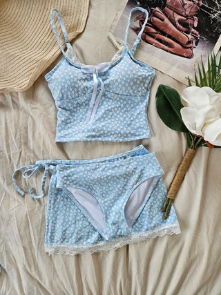 A pure sky blue floral piece set with a crop top belly-covering wrap skirt and a beach look/vacation look cover-up swimsuit.