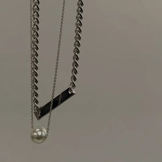 chain layered with pearl necklace