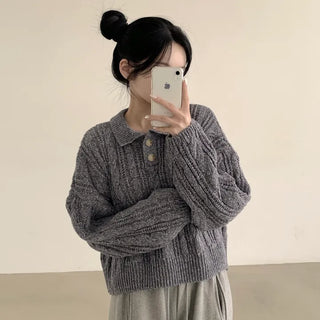 Cute loose-fit long-sleeve knit with collar buttons and cable knit featuring voluminous sleeves