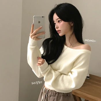 Soft one-off shoulder semi-cropped waist-cinched avant-garde long-sleeve knit with a cinched fit that covers the back of the hands