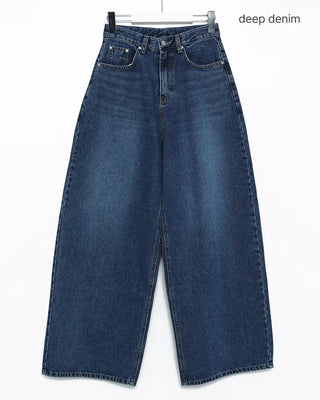 Wide-leg jeans with faded whisker wash.