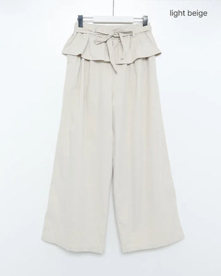 Wide-leg pants with pleats and peplum belt