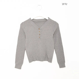 V-neck ribbed knit with gold buttons.