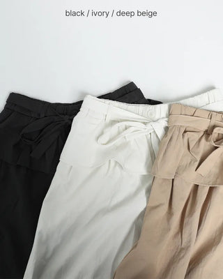 Wide-leg pants with pleats and peplum belt