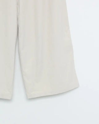 Wide-leg pants with pleats and peplum belt
