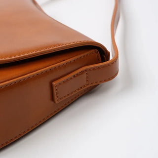 Round flap shoulder bag
