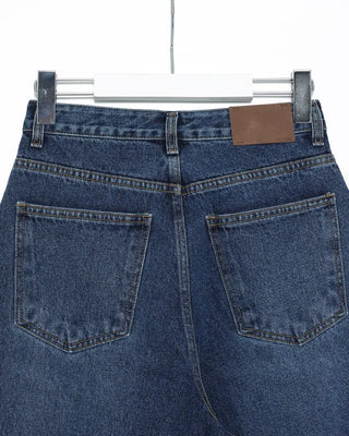 Wide-leg jeans with faded whisker wash.