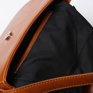 Round flap shoulder bag