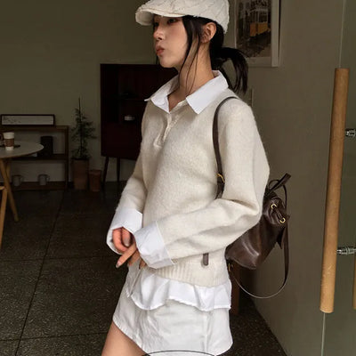 Oversized knit sweater with contrasting shirt collar.