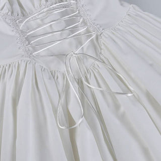 Long sleeve smocked lace up lace hem mini dress