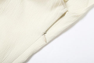 Off shoulder irregular solid zip-up top