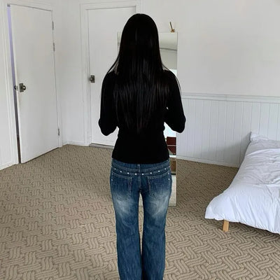 Dark blue bootcut denim with studded rivet pockets