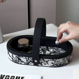 Oval-shaped leather jacquard tray with handlein .
