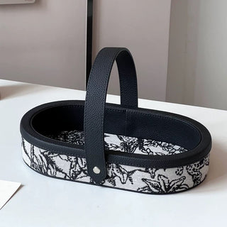 Oval-shaped leather jacquard tray with handlein .